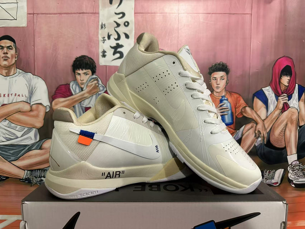 Two pale cream basketball shoes displayed together, showing the perforated panels, translucent side details, and AIR midsole text.