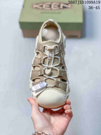 Top view of the sandal showing the toe guard, webbing straps, toggle-style lacing, and padded footbed.