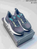 Pair of navy adidas AlphaBounce Beyond sneakers with teal accents and white midsoles on a shoebox.