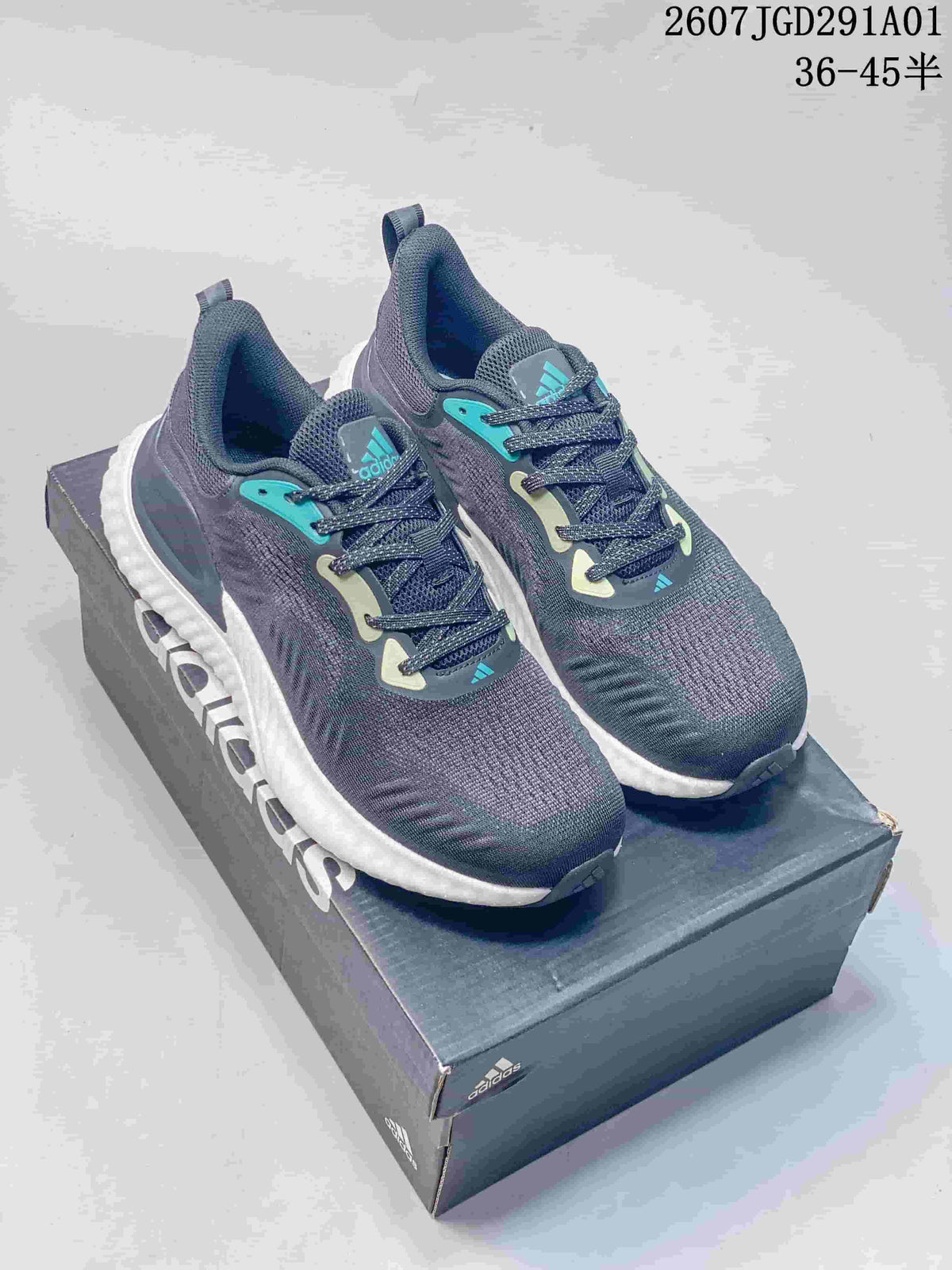 Pair of navy adidas AlphaBounce Beyond sneakers with teal accents and white midsoles on a shoebox.