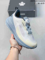 Angled side view showing the white and light blue colorway, side detailing, heel pull tab, and dial closure.