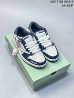 Pair of black-and-white Jordan low-top sneakers displayed on a mint-green shoebox, showing Labubu tongue graphics and a plush side charm.