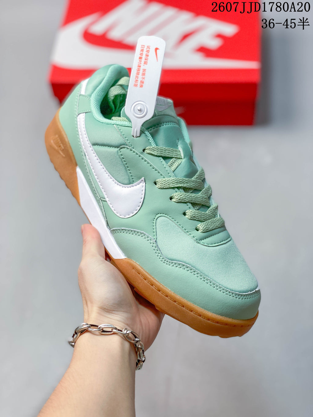 Angled side view showing the mint green and white upper with gum-colored sole.