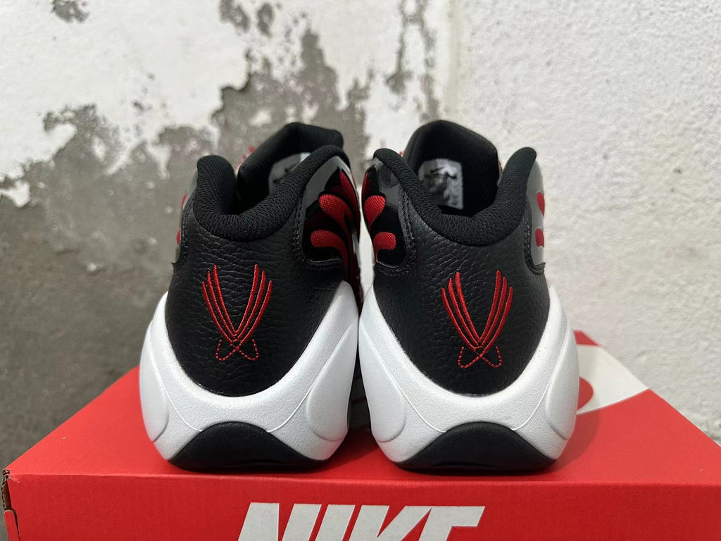 Rear view of red, black, and white Nike Flight sneakers showing embroidered heel details