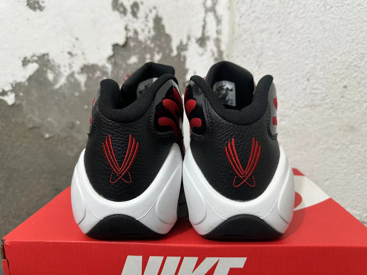 Rear view of red, black, and white Nike Flight sneakers showing embroidered heel details