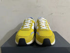 Front view showing the yellow toe panels and white laces on New Balance U370 sneakers
