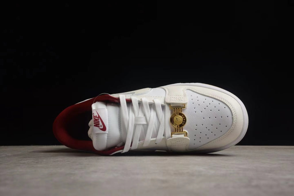 Top view of one sneaker showing the perforated toe box, laces, layered overlays, and gold-tone clasp.