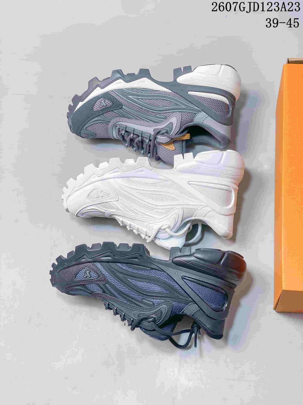 Three Louis Vuitton Summit sneakers shown from the side in dark gray, white, and gray-blue color variations.