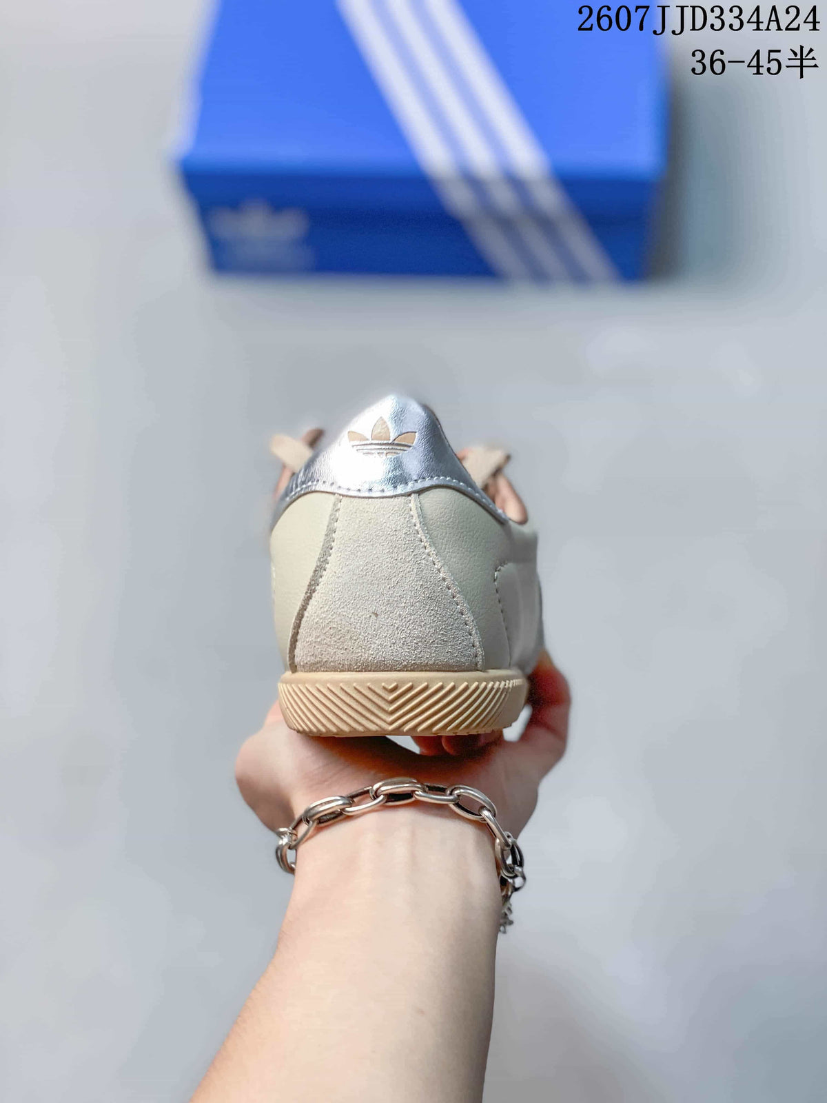 Rear view of the sneaker showing the silver heel detail and gum-colored outsole.