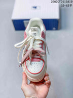 Top view of the sneaker showing the perforated toe panel, white and pink trim, and two contrasting lace colors.