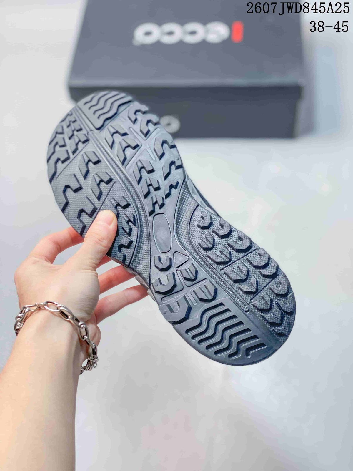 Close-up of the patterned rubber outsole on a dark ECCO sneaker, showing its textured traction design.