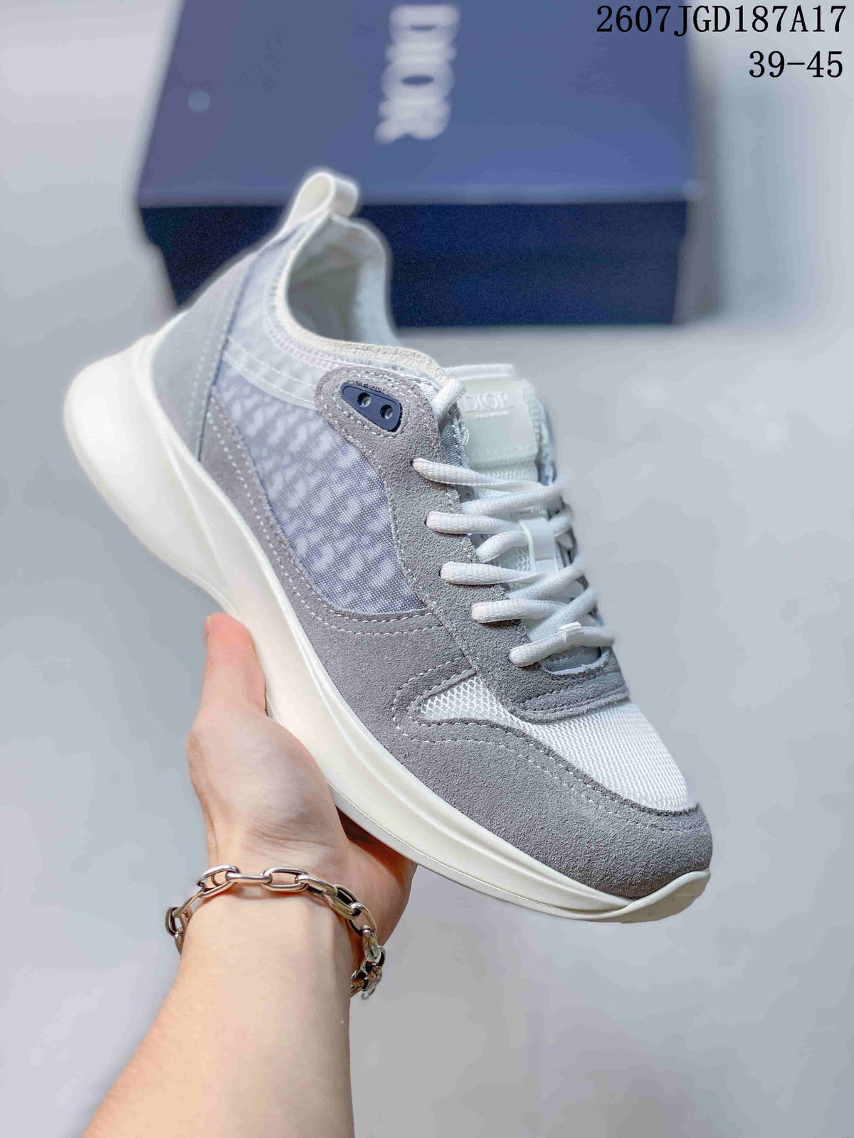 Gray and white Dior B25 Runner sneaker with a textured side panel and light rubber outsole.