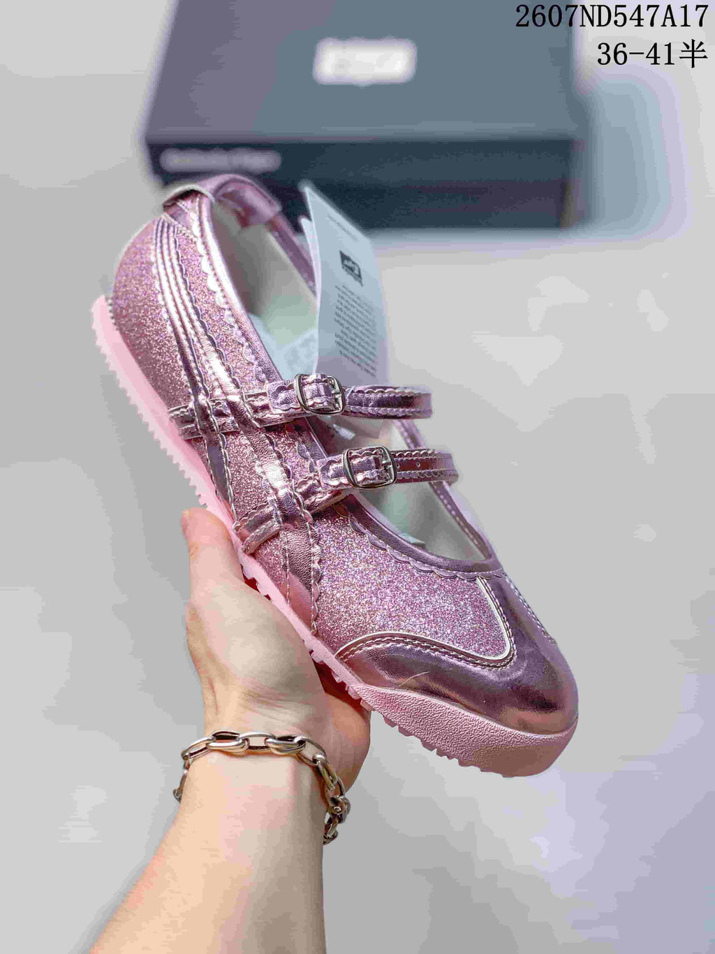 Metallic pink Mary Jane sneaker with reflective detailing, two buckle straps and a pink sole.