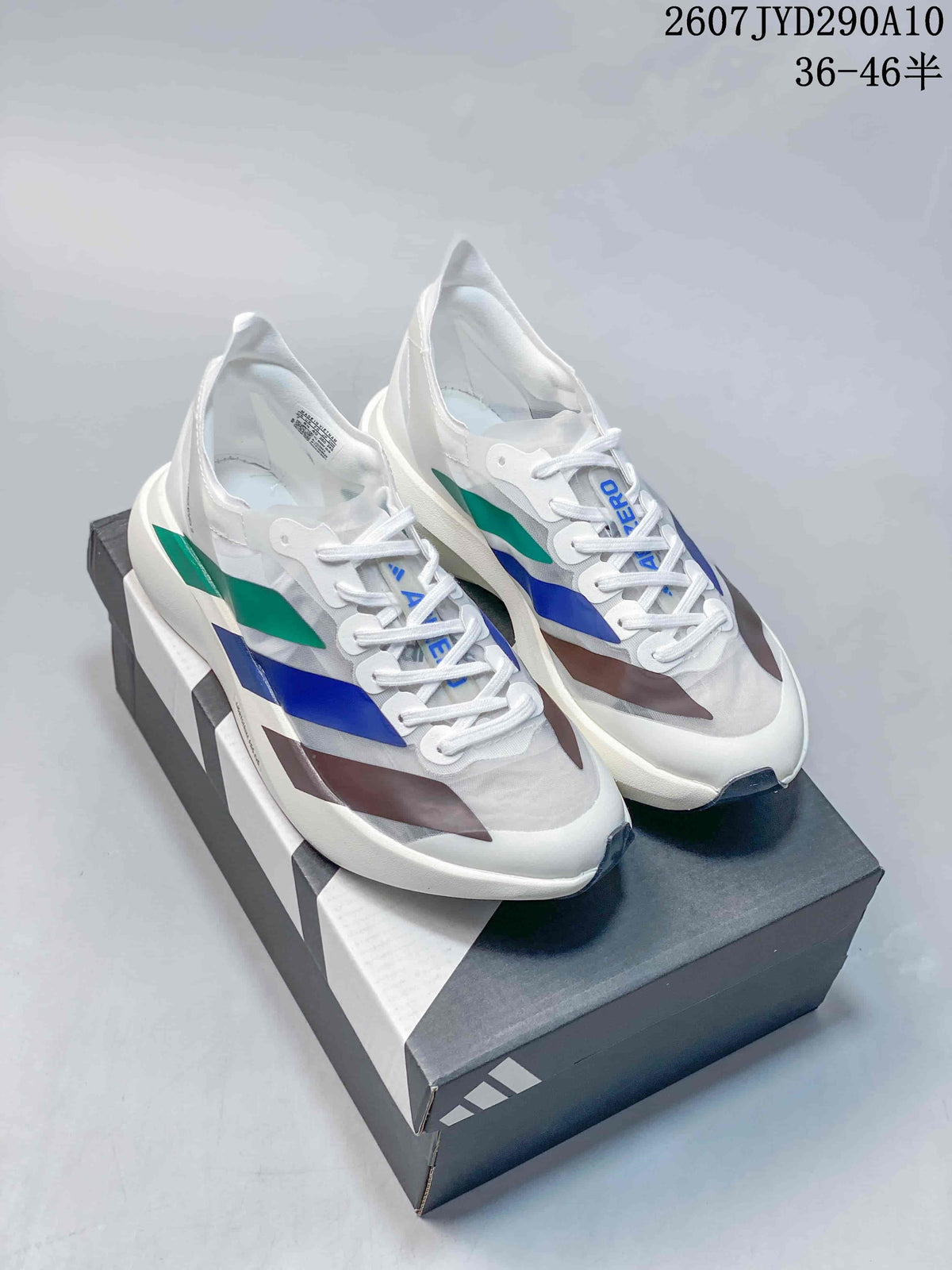 Pair of white Adidas Adizero Adios Pro Evo 2 running shoes with blue, green and dark accent panels displayed on a shoe box.