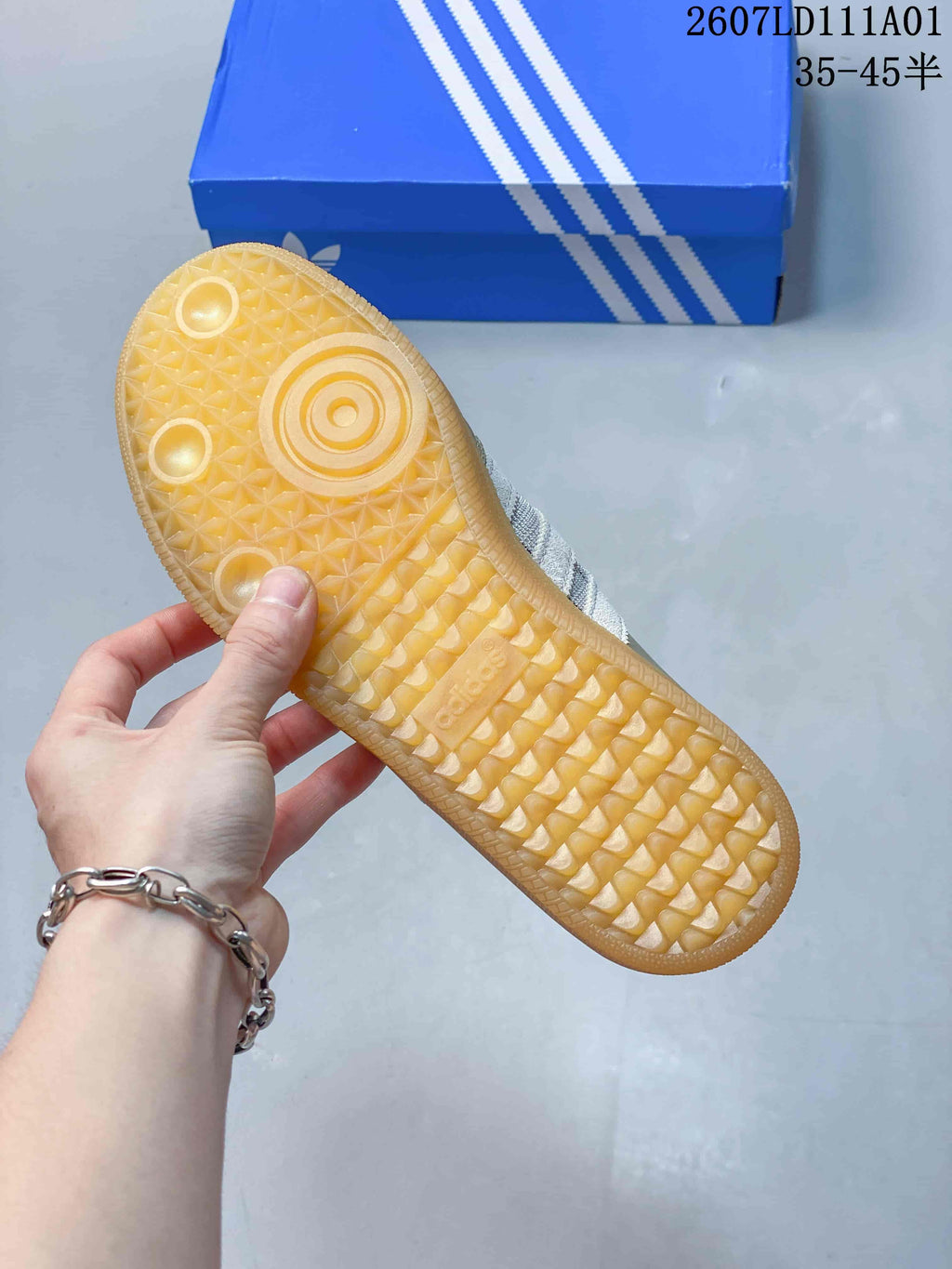 Underside of a sneaker showing a gum-colored patterned sole
