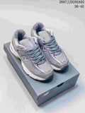 Pair of gray, white, and red New Balance 509 sneakers displayed on a shoebox; image text shows style code 2607JJD292A02 and size range 36–45.