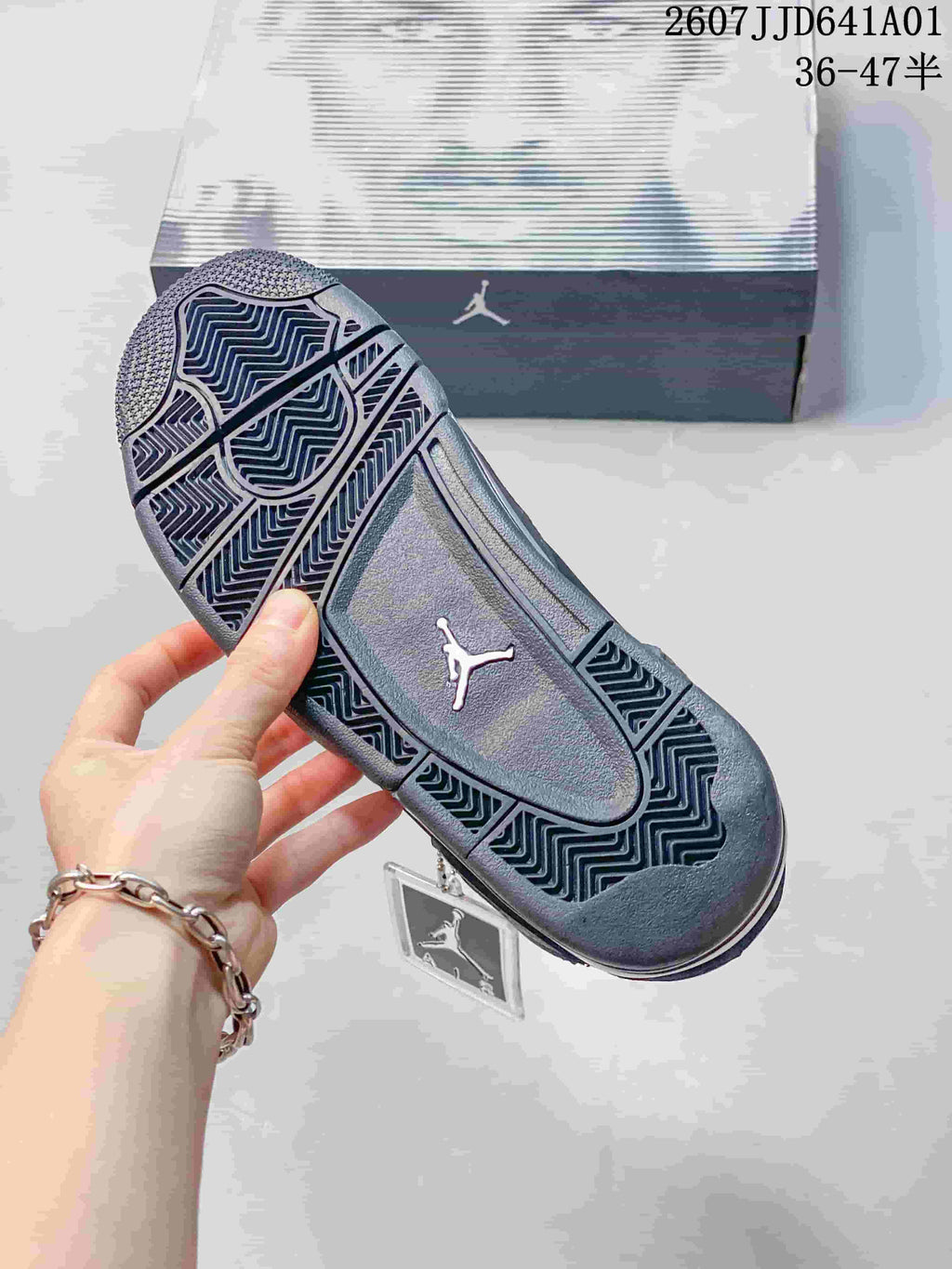 Close view of the patterned outsole on a dark sneaker