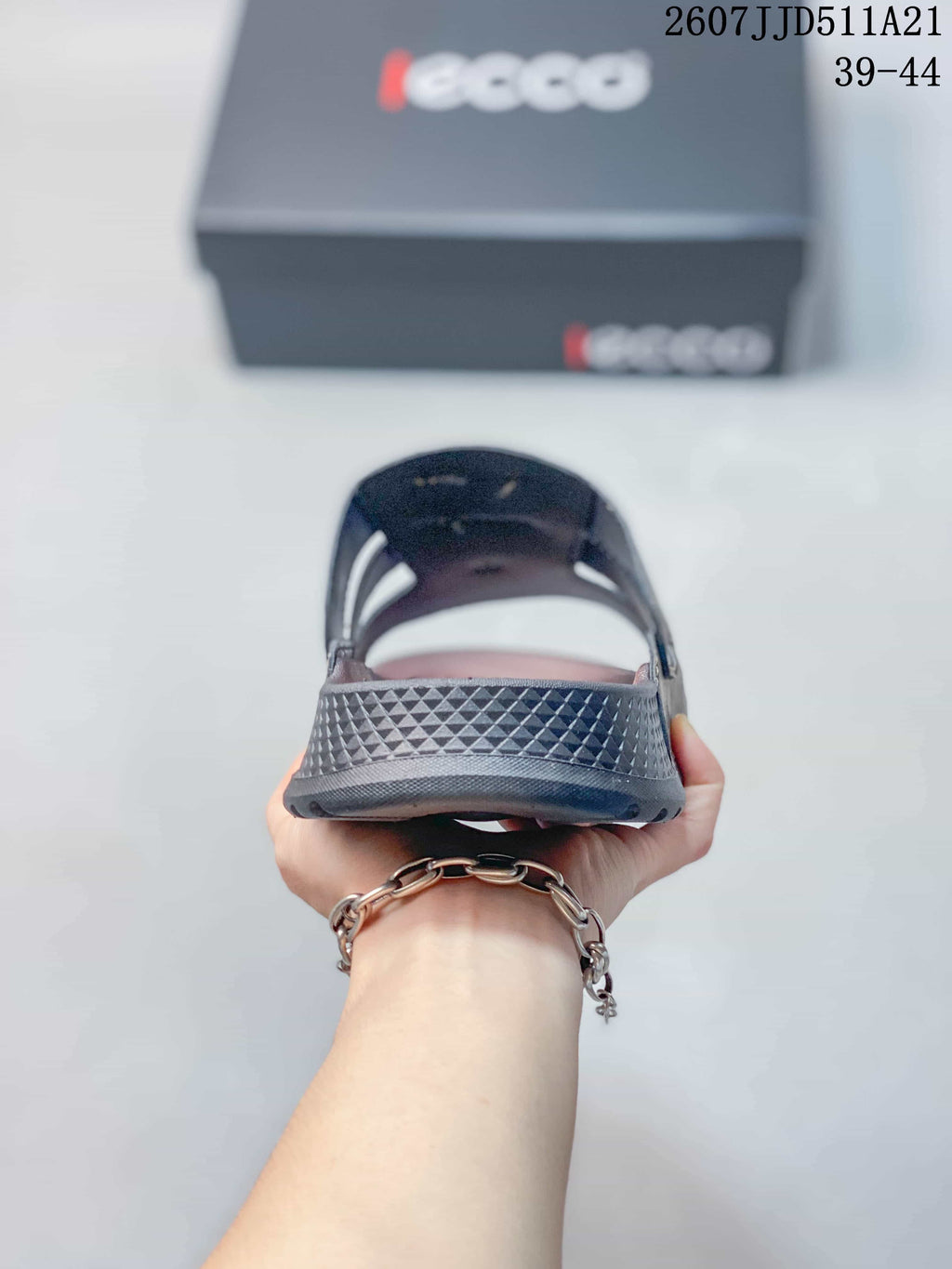 Rear view of the sandal showing the textured heel section and dark outsole.