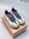 Pair of white, gray, and red Norda 001 trail shoes displayed on a Norda box.