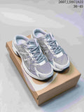 Pair of white and silver ASICS Gel-1130 sneakers displayed on a shoebox; style code 2607JJD972A22 and size range 36–45 are visible.