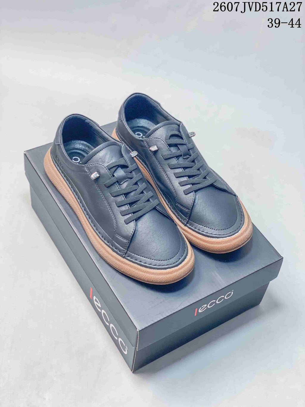 Pair of dark navy ECCO low-top sneakers displayed on an ECCO shoebox, with style code 2607JVD517A27 and size range 39–44 visible.