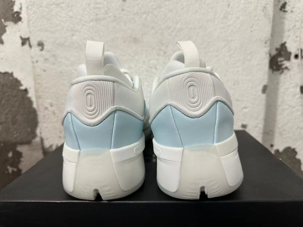 Rear view of white and light blue Adidas Dame 9 shoes