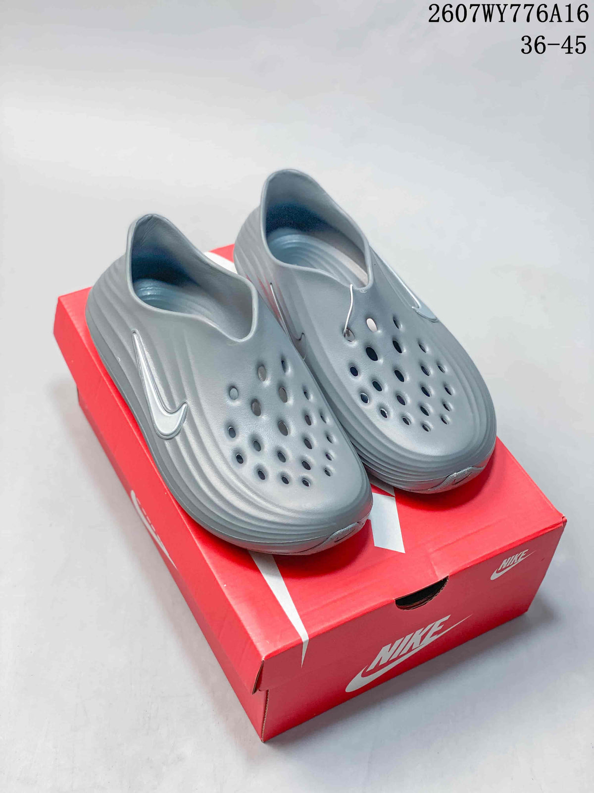 Pair of gray Nike ReactX Rejuven8 clogs displayed on a red Nike shoe box.