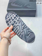 Close view of the patterned gray outsole with raised traction lugs and visible Nike branding.