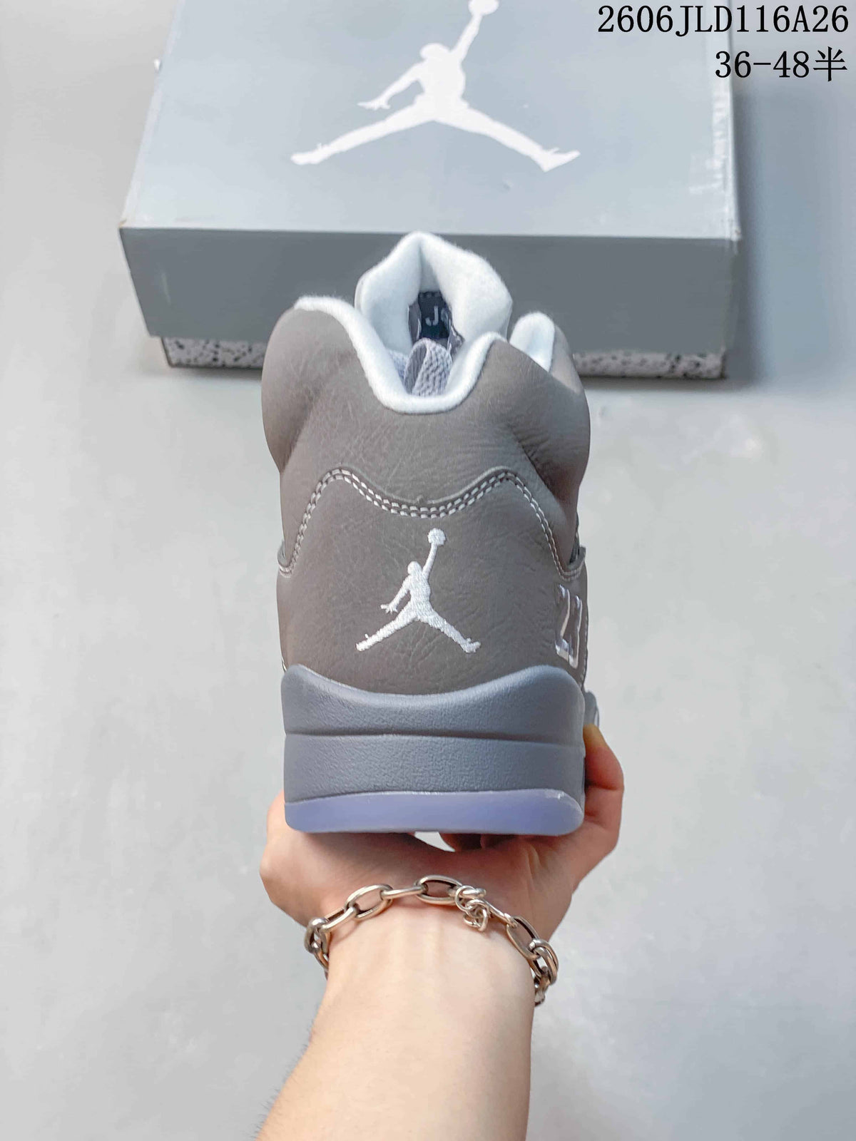 Rear view showing the embroidered Jumpman logo on a grey Jordan sneaker