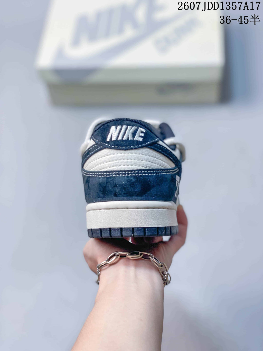 Rear view of the navy and white sneaker showing the heel branding and outsole edge.