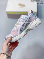 Side profile of the silver and pink ASICS sneaker showing mesh panels, layered overlays, and the structured midsole.