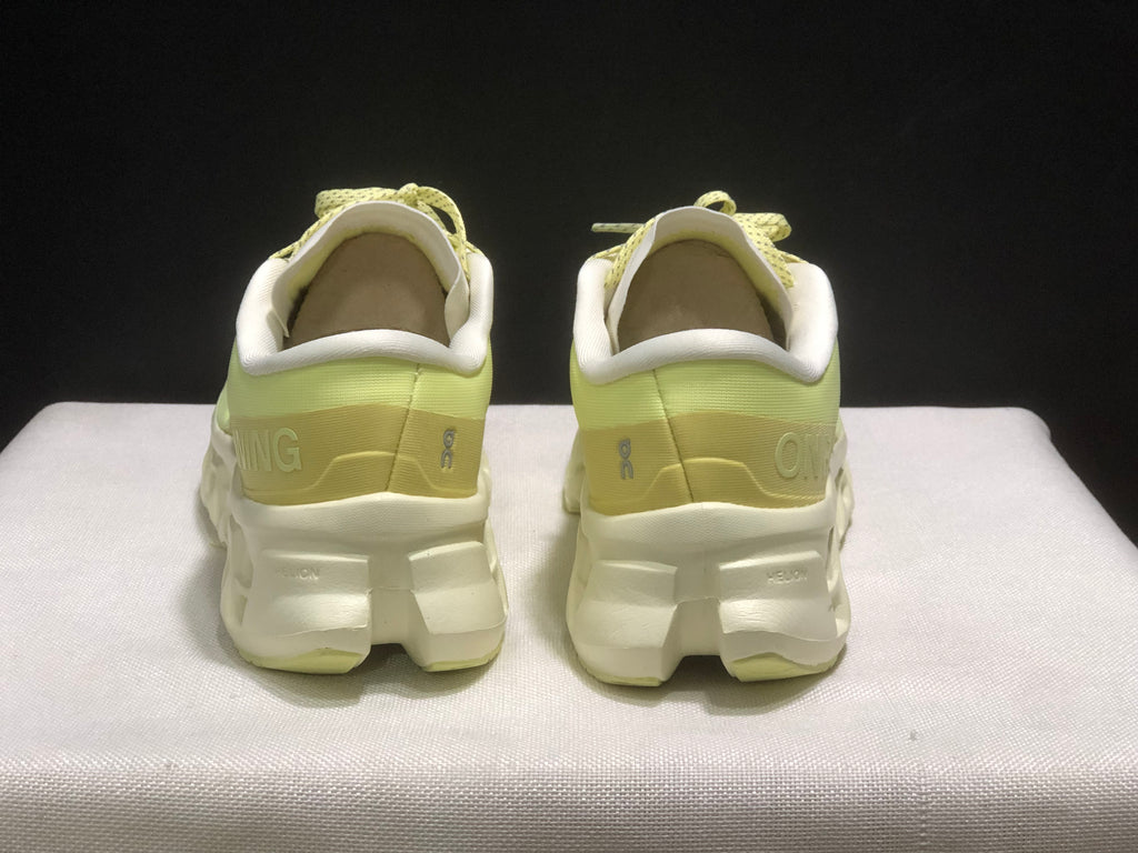 Rear view showing the padded collars, heel structure, and white segmented midsoles.