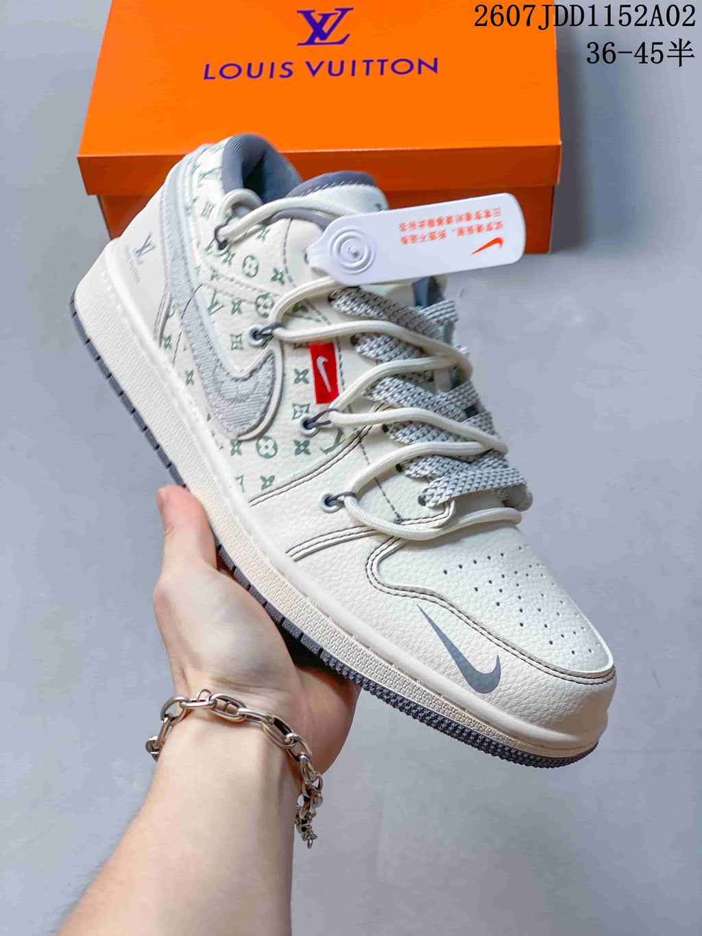 Close-up of a white low-top sneaker with repeating patterned panels and gray accents.