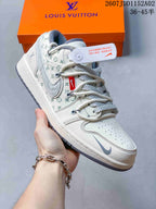 Close-up of a white low-top sneaker with repeating patterned panels and gray accents.