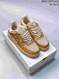 Pair of tan and cream Nike low-top sneakers displayed on a shoebox, showing the woven-texture panels, tonal overlays, and lace-up design.