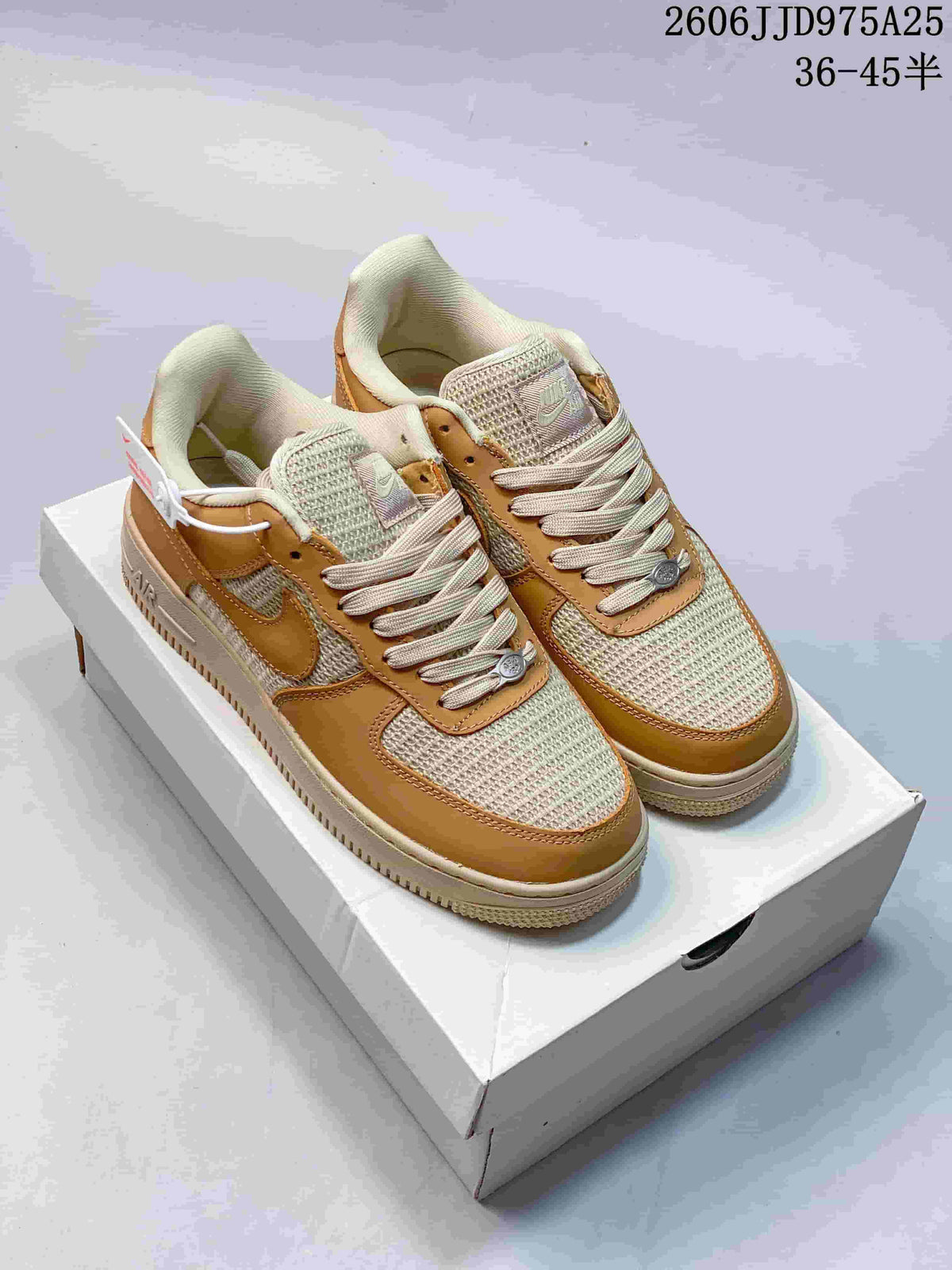 Pair of tan and cream Nike low-top sneakers displayed on a shoebox, showing the woven-texture panels, tonal overlays, and lace-up design.