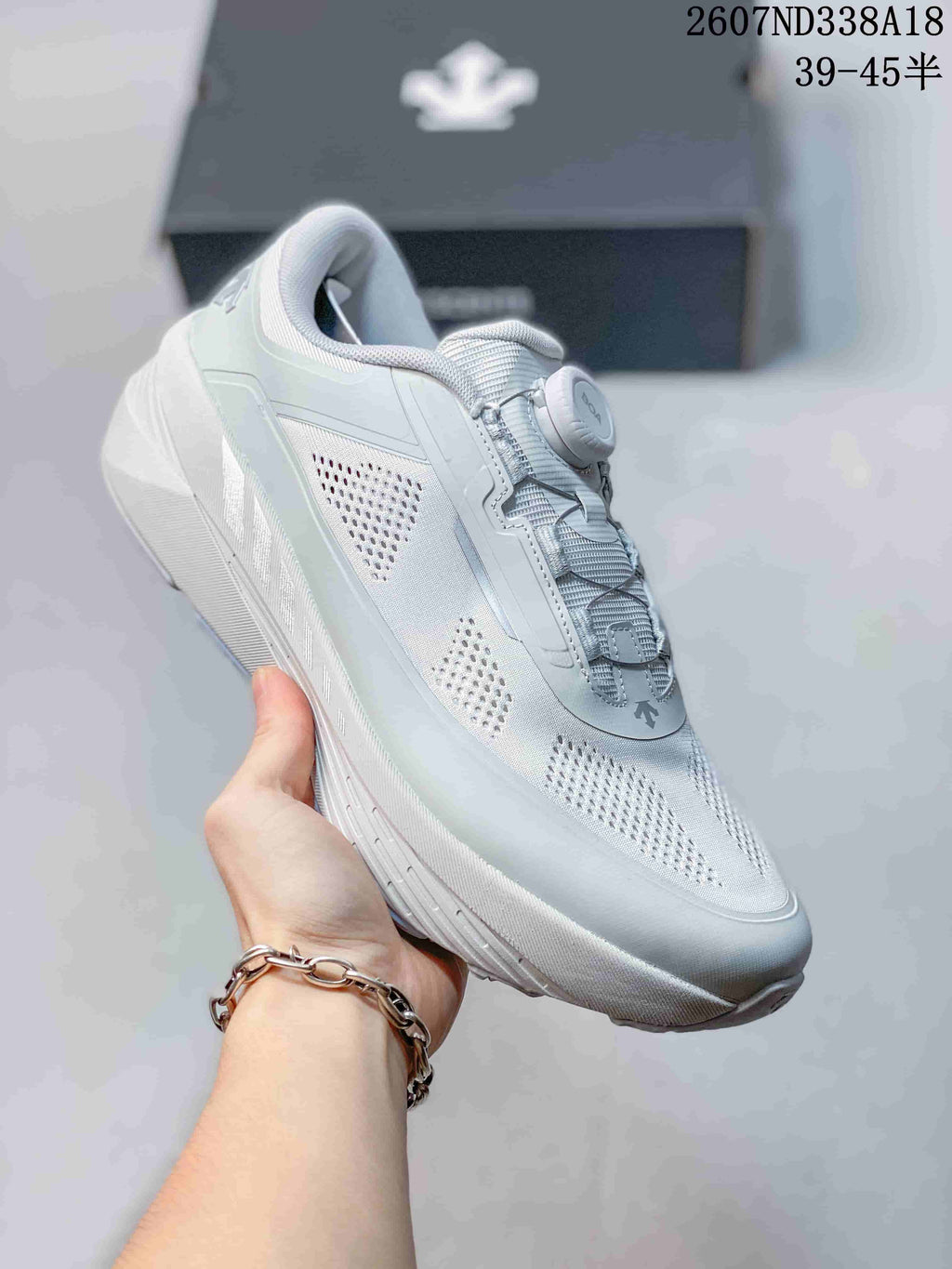 Angled side view of the white sneaker showing the mesh upper, BOA closure, padded collar, and thick sole.