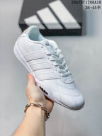Angled side view showing the white upper, lace-up closure and adidas branding near the sole.