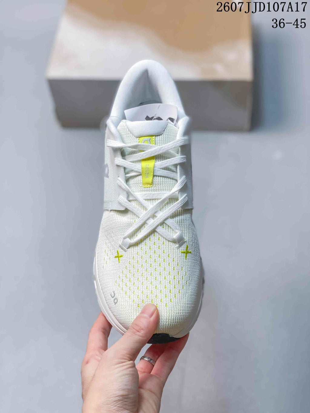 Top view of the sneaker showing white laces, lime tongue details, and perforated forefoot pattern.