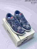 Pair of navy and gray plaid low-top sneakers displayed on a Nike shoebox.