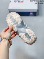 Bottom view of a FILA sneaker showing the sculpted raised outsole tread.