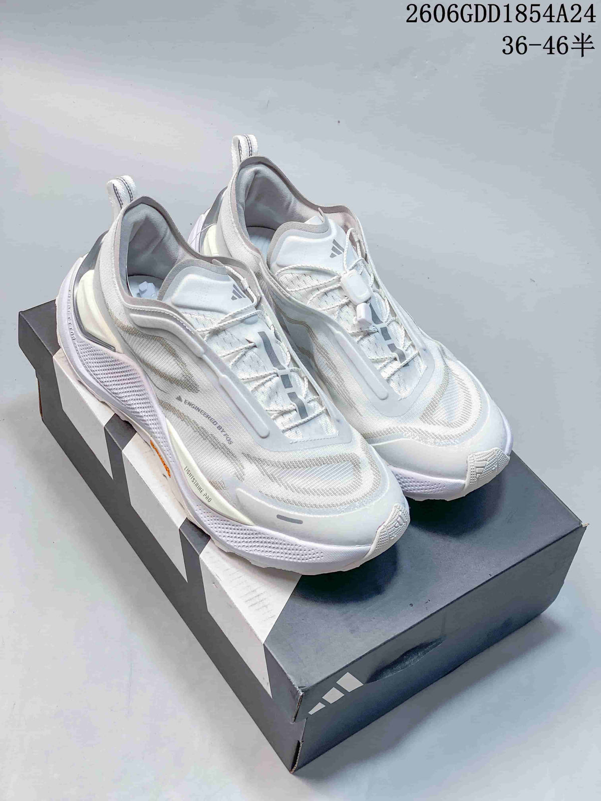 Pair of white and light-gray Adidas Holo Peak low-top trail-running shoes on a shoebox