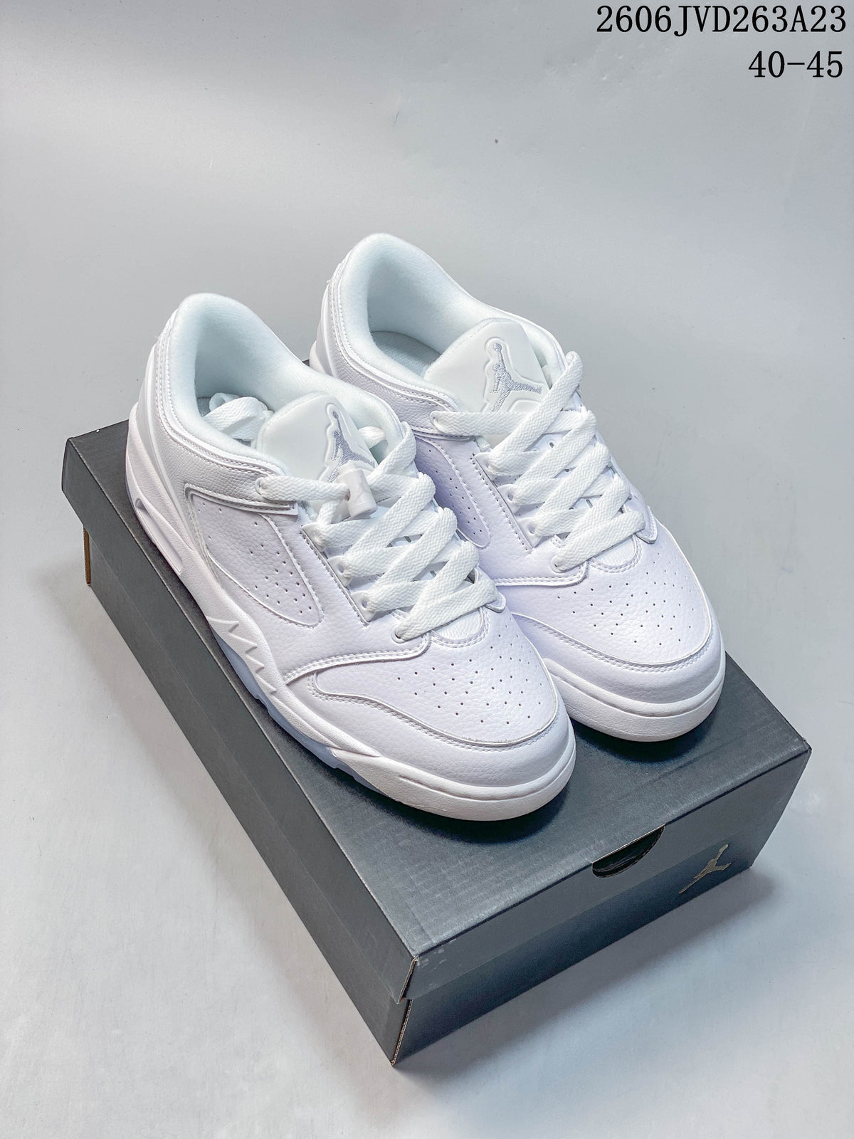 Pair of white Jordan Sixty Plus Low sneakers shown from above on a shoe box