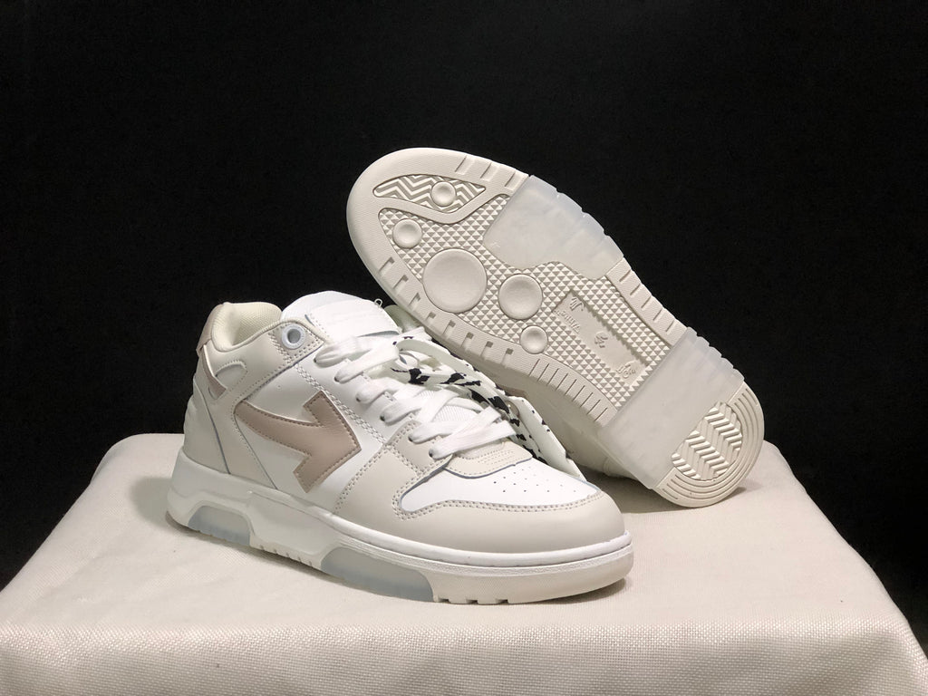 Angled view showing one sneaker outsole with circular tread details and the layered upper design of the other shoe.