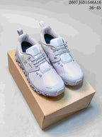 Pair of light gray On sneakers displayed on a cardboard box, showing the upper, laces, side branding and segmented outsole.