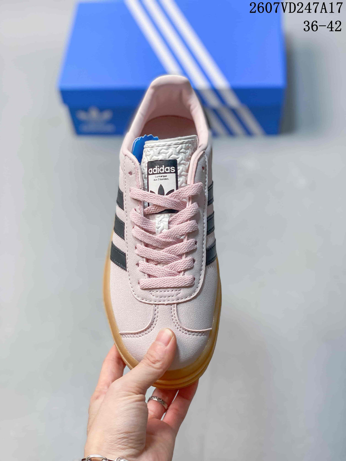Top view showing the pink laces, pale pink toe box, and adidas tongue label.
