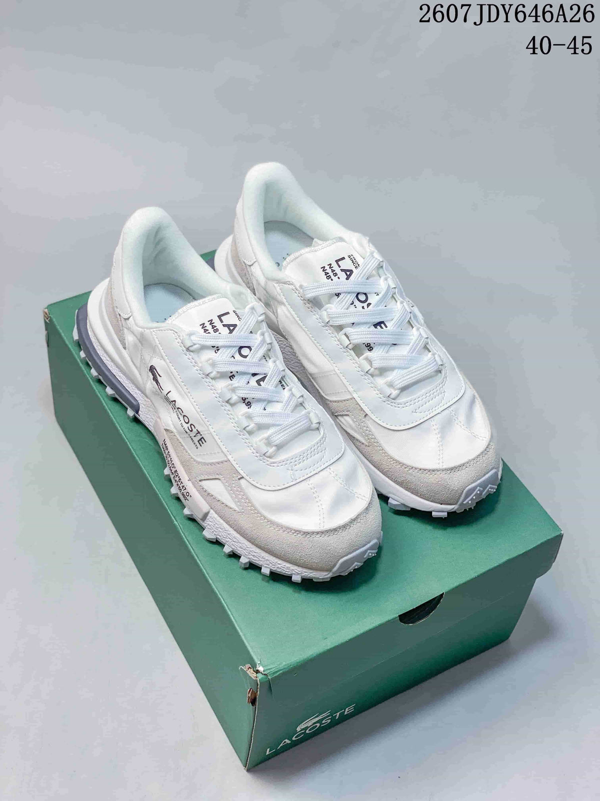 Pair of white and gray Lacoste low-top sneakers displayed on a green shoe box; image text shows style code 2607JDY646A26 and size range 40–45.