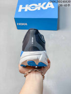 Rear view of a HOKA Arahi 8 shoe with a white midsole and blue outsole sections.