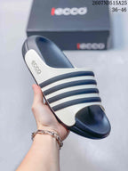 Angled view of a navy and white ECCO slide sandal showing the open toe, contrasting bands, and side branding.