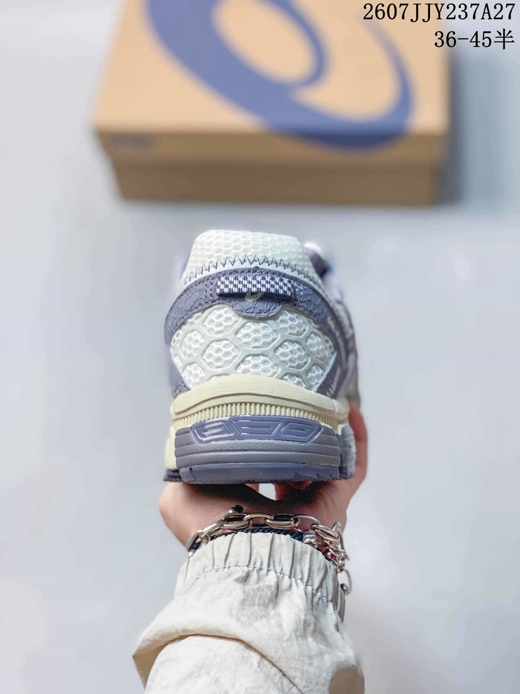Rear view showing the padded heel, layered heel panels, and contrasting outsole.